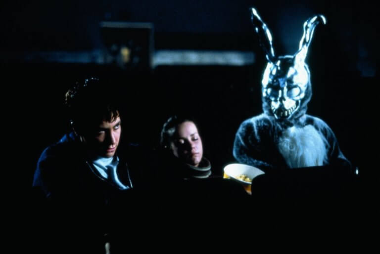 Donnie and Gretchen sit in a movie theater with a monstrous bunny creature