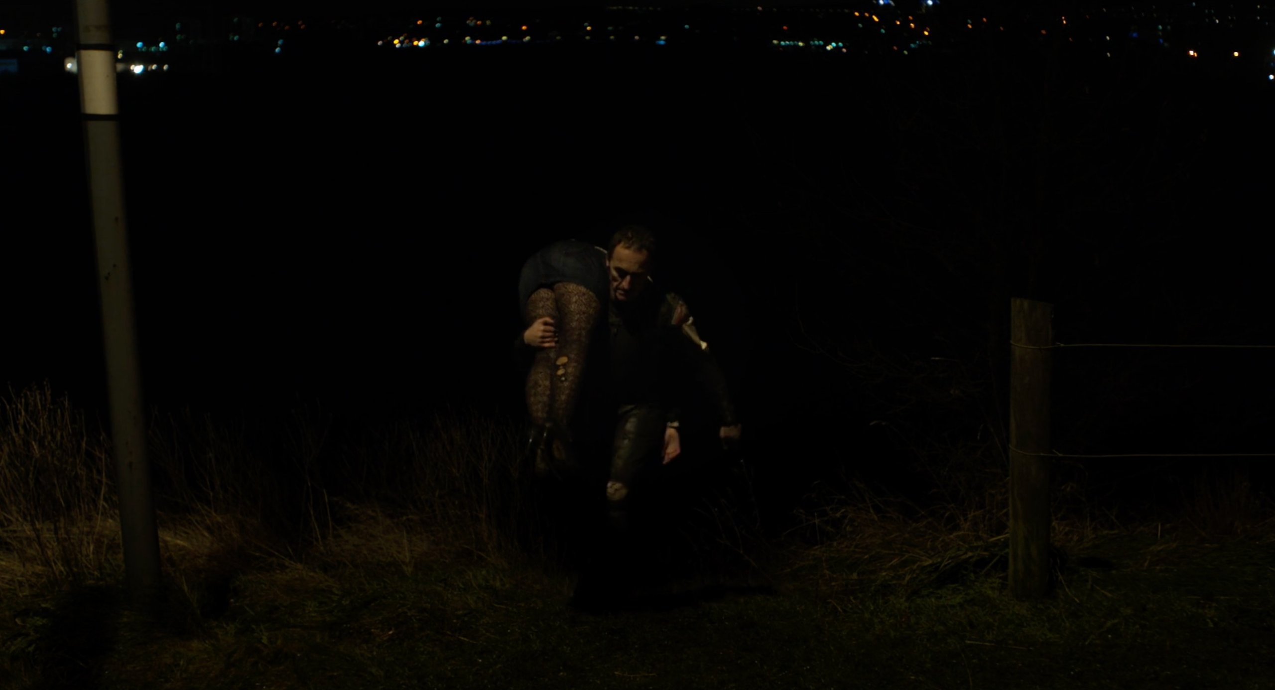 The Motorcycle Man carries a dead woman in Under the Skin