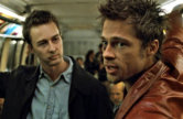 Brad Pitt and Edward Norton stand on a subway train in Fight Club