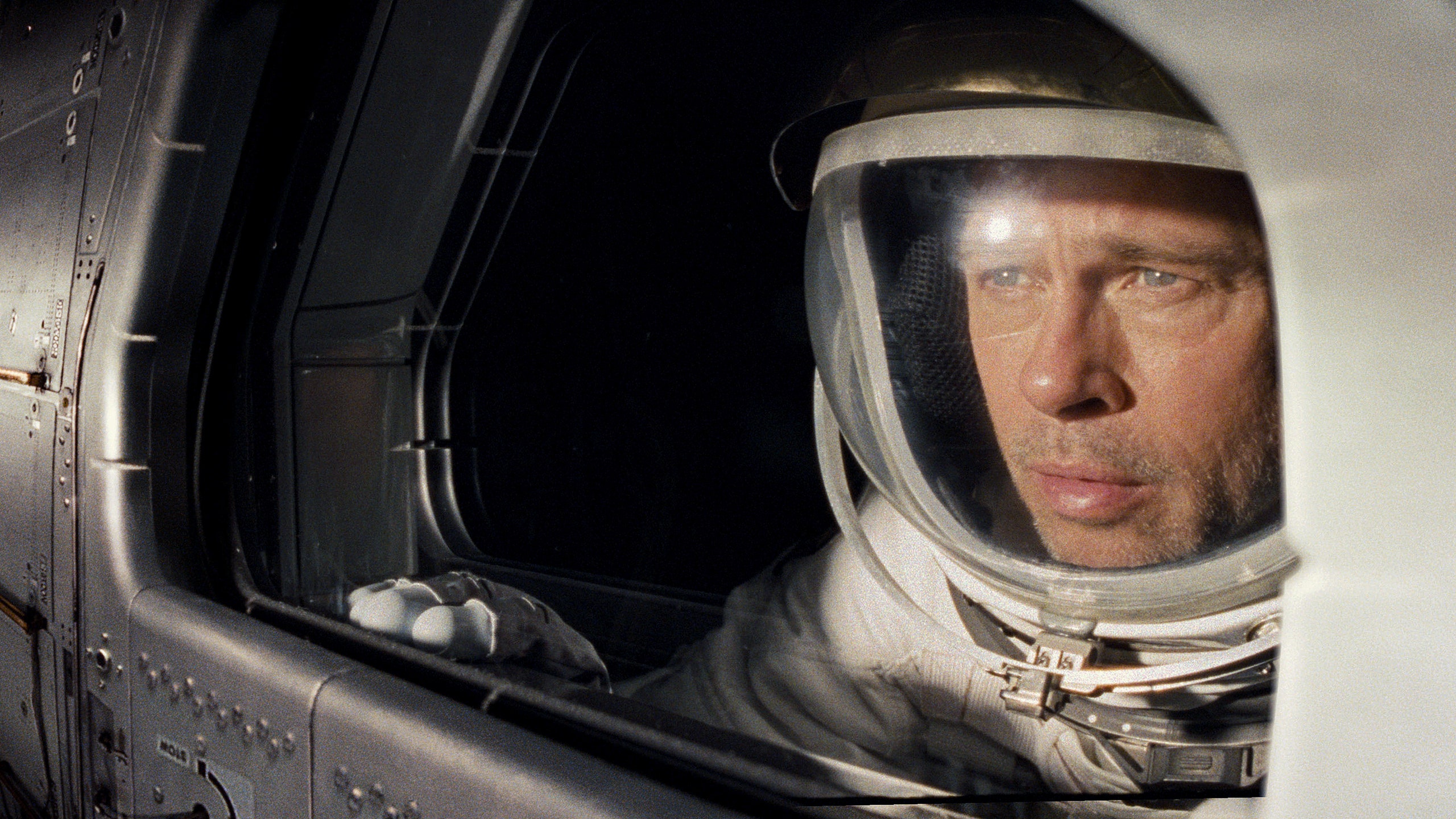 Roy McBride (Brad Pitt) peers out the window of a spaceship in Ad Astra