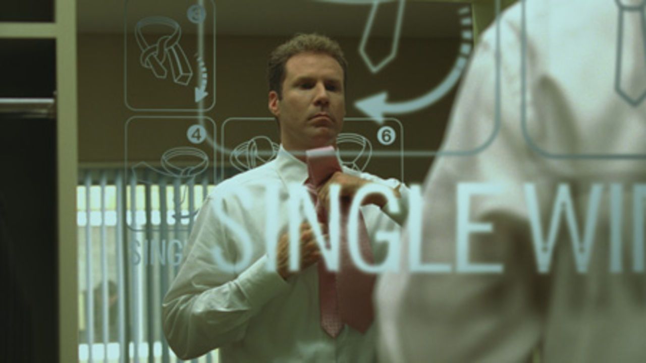 Harold Crick (Will Ferrell) puts on his tie in the mirror as words flash on the screen in Stranger Than Fiction