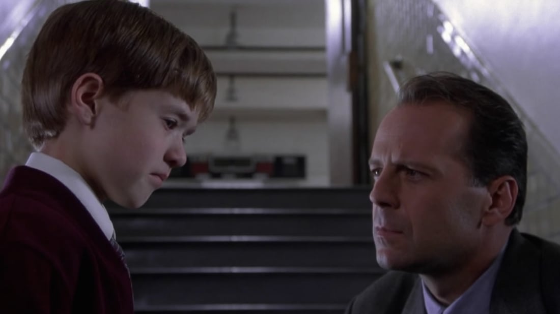  Bruce Willis (Dr. Malcolm Crowe) bends down to speak with Cole Sear (Haley Joel Osment) in The Sixth Sense