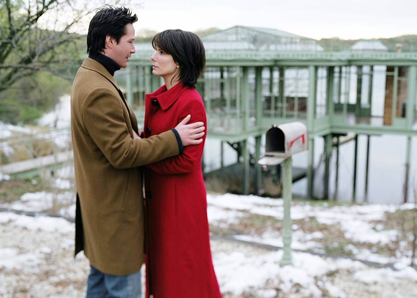 Alex Wyler (Keanu Reeves) and Kate Forster (Sandra Bullock) embrace one another in The Lake House