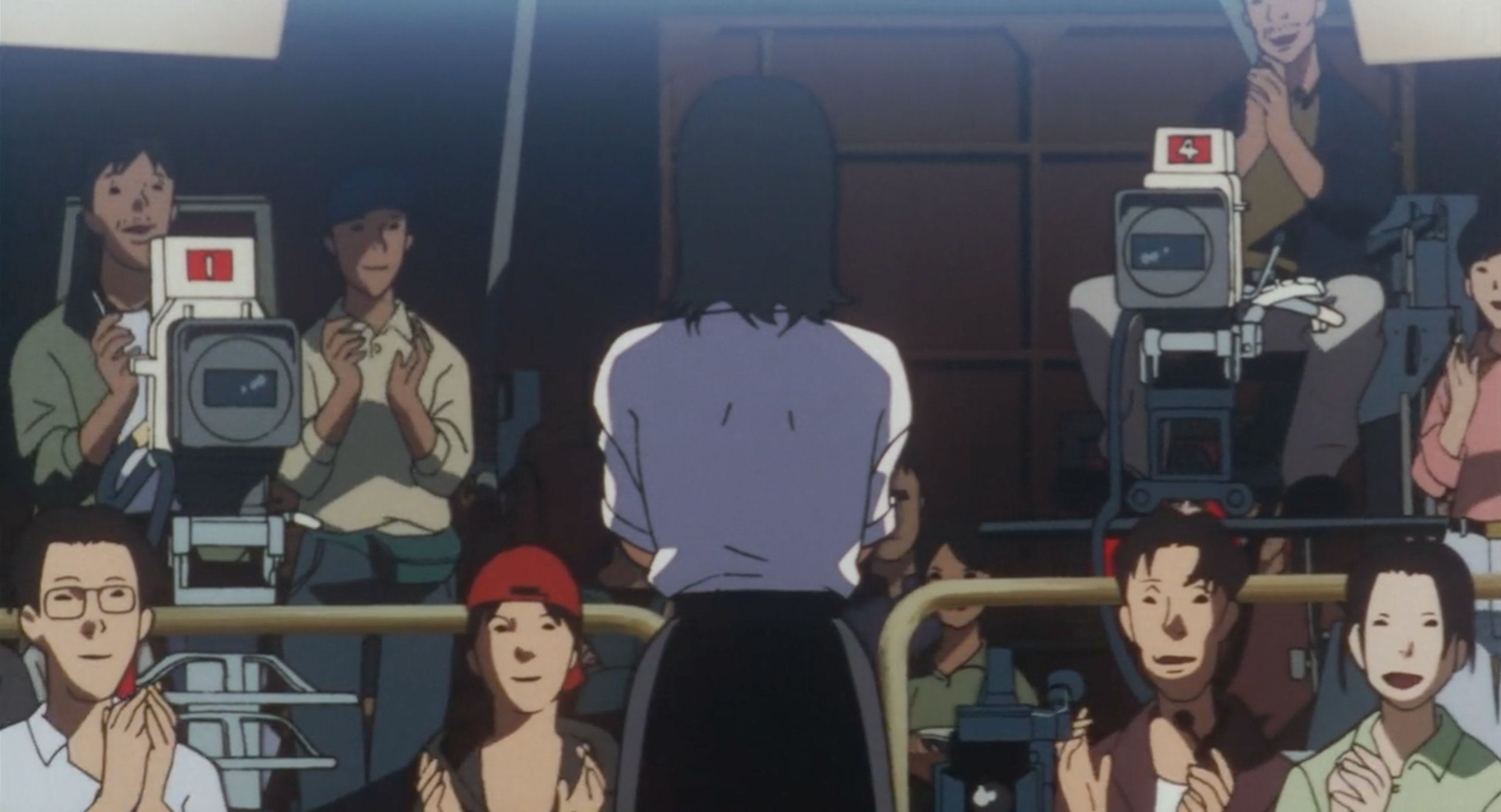 The Double Bind crew applauds Mima after a shoot in Perfect Blue