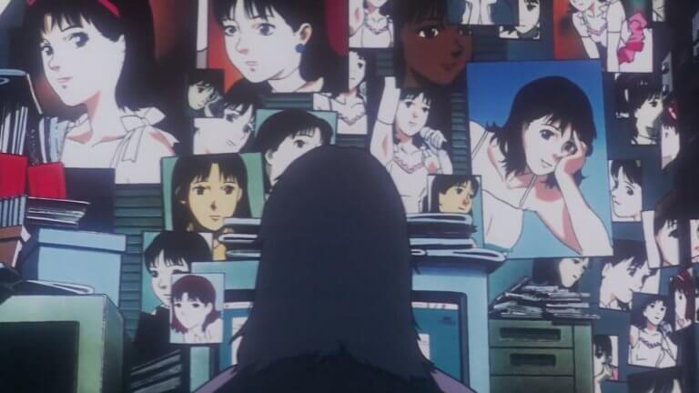 Me-Mania sits at his computer with pictures of Mima all over his office in Perfect Blue