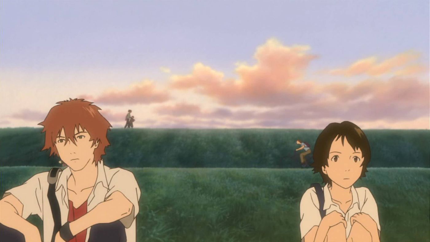 Chiaki and Makoto sit together outside a field in The Girl Who Leapt Through Time