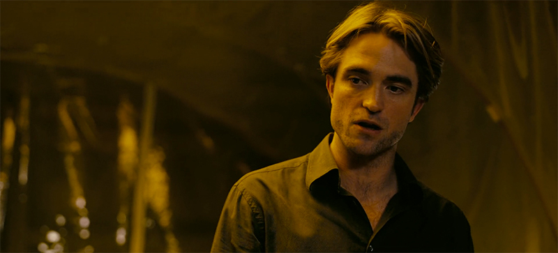 Neil (Robert Pattinson) speaks with the Protagonist and Kat in the back of a van in Tenet