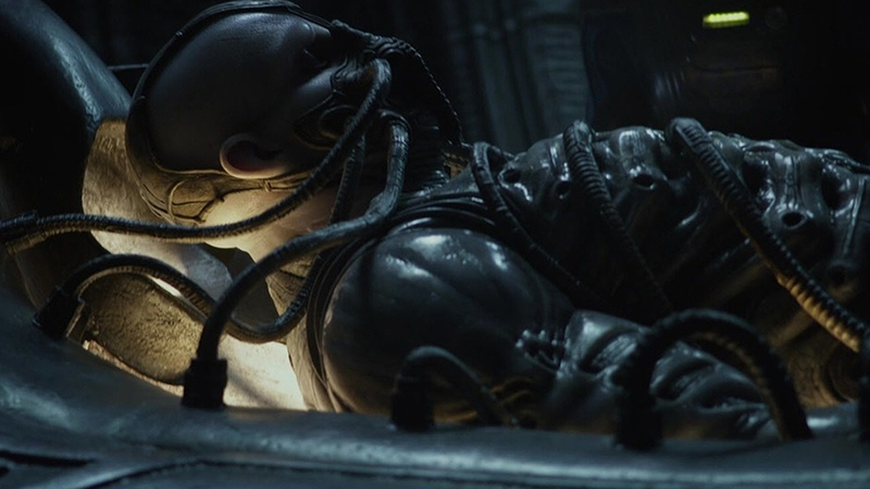 An Engineer lies on a table wrapped in tubes in the film Prometheus