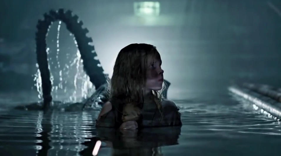 Rebecca (Carrie Henn) walks in the water a Xenomorph approaches from behind in Aliens