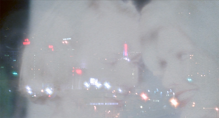 Betty (Naomi Watts) and Rita (Laura Harring) appear in a white haze over the cityscape of Los Angeles at the end of Mulholland Drive