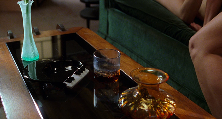 A piano ash tray and a whiskey drink sit on Diane's table in Mulholland Drive