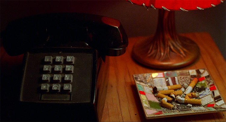 A black telephone, an ashtray, and a red lampshade in Mulholland Drive