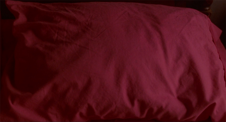 A red pillow in Diane's bedroom in Mulholland Drive