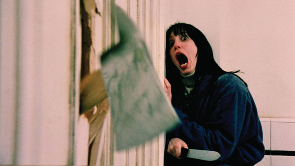 A woman screams as an axe smashes through a door