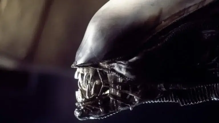 An black alien bares its sharp teeth