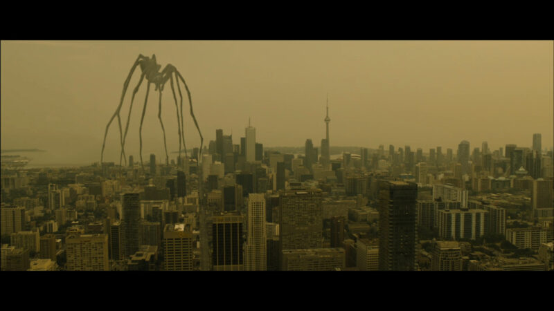 A giant spider walks over a city
