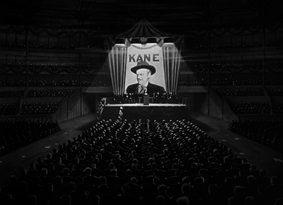 An audience attends a rally for Charles Foster Kane