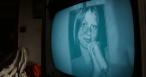 A woman's picture on an old television screen