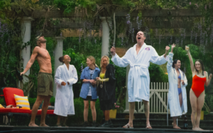 A group of friends stands outside a pool and scream in the rain