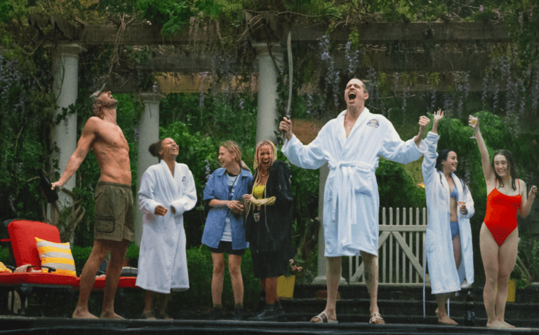 A group of friends stands outside a pool and scream in the rain