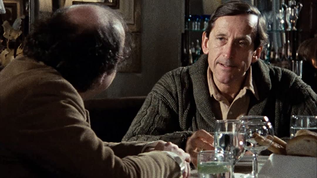 Two men sit at a table together at a restaurant