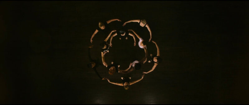 A group of ballerinas dance in a circle