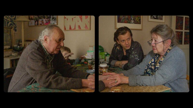 A split screen of a older man holding an older woman's hands across a table as a younger man and a child sit nearby
