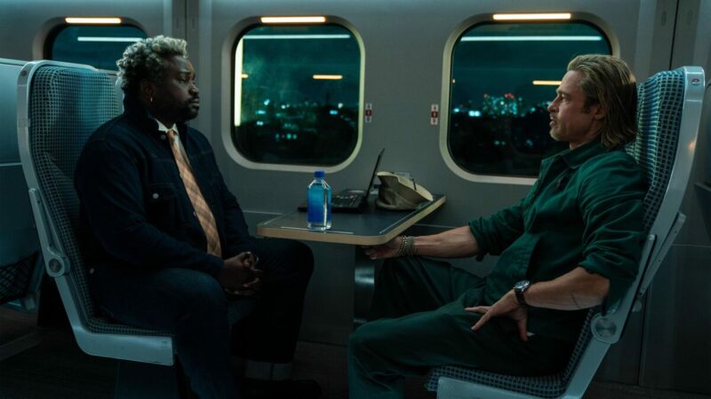 Two men sit on a train