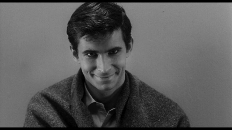 Norman Bates looks into the camera with a sinister smile