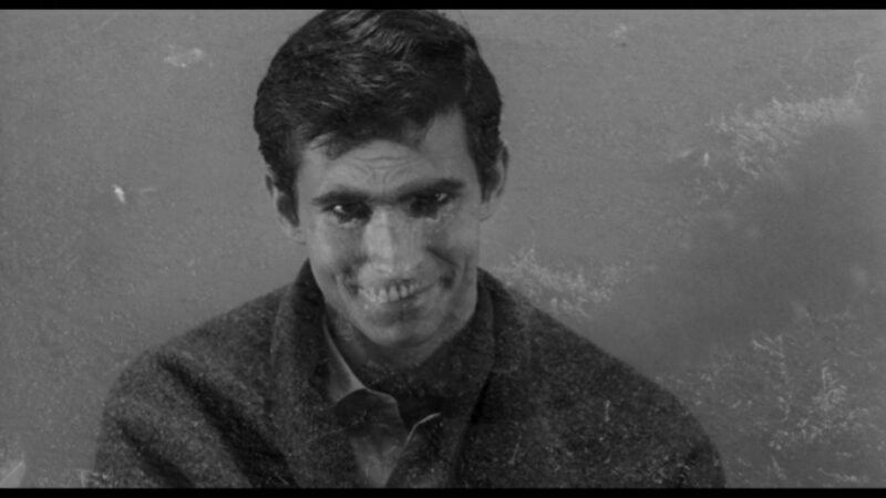 A skeleton is superimposed over smiling Norman Bates's face