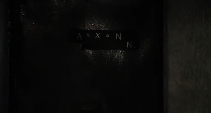 The letters "Axxon N" appear on a door