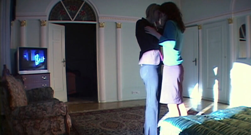 Two women embrace and kiss