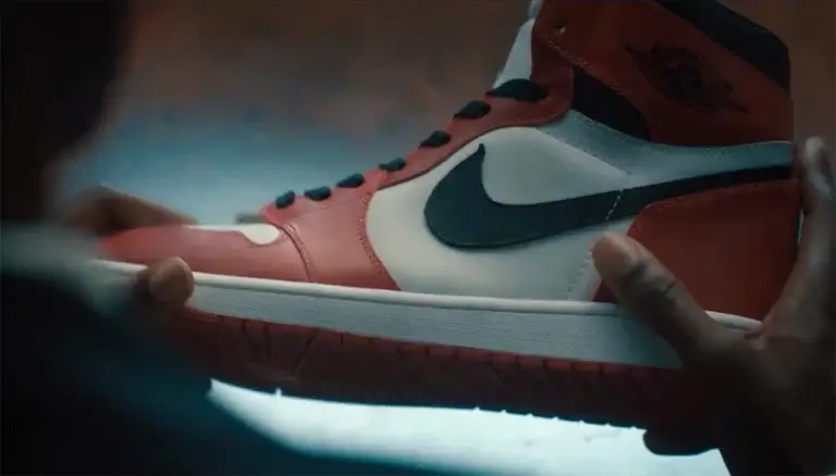 Someone holds an Air Jordan 1 in their hands.