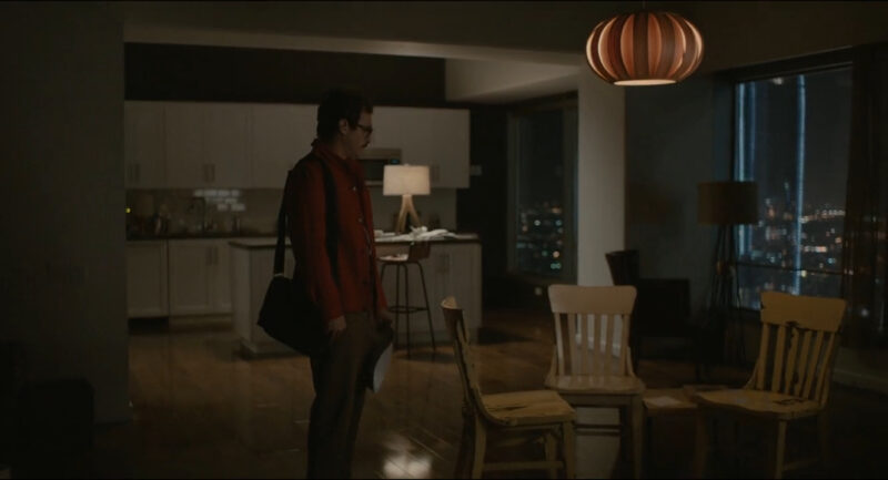 A man stands alone in his apartment