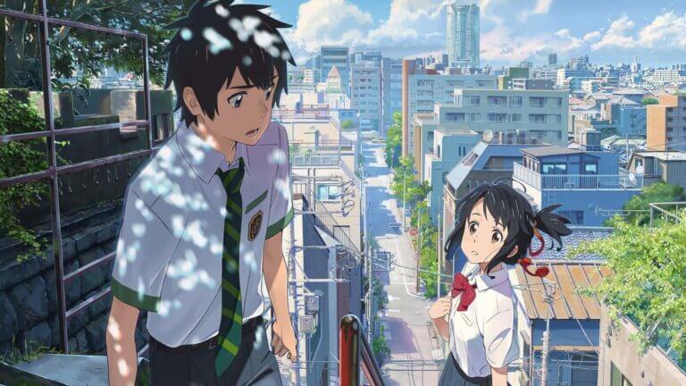 A boy and a girl look at one another outside a city