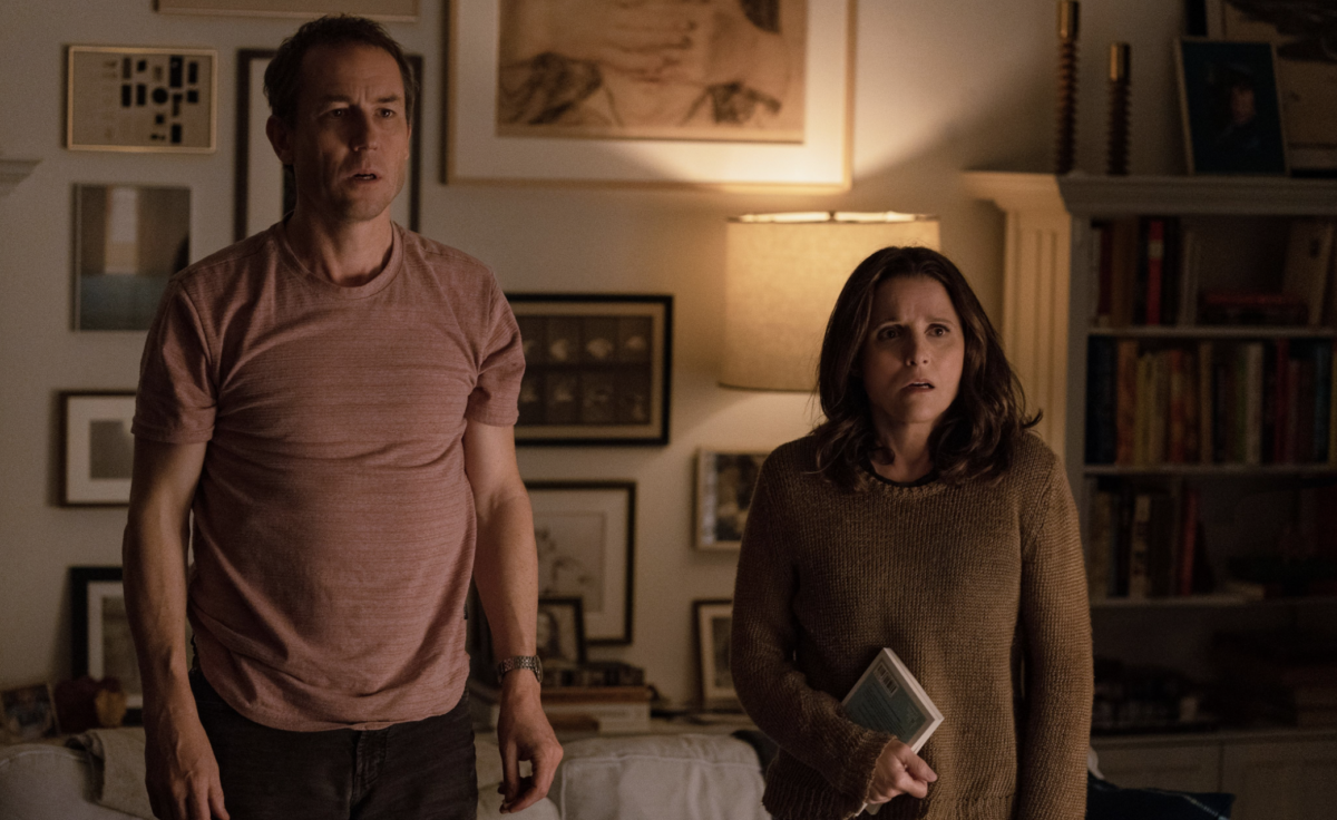 Don and Beth stand in the living room of their home and are shocked by something they hear.