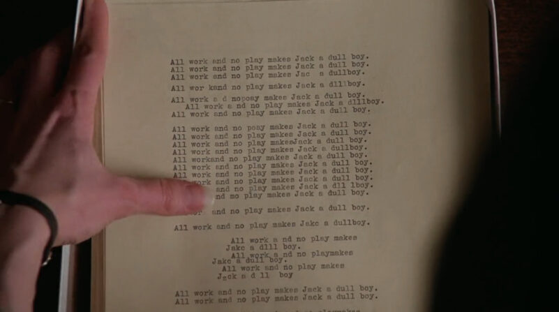 The phrase "all work and no play makes Jack a dull boy" is repeated on a piece of paper