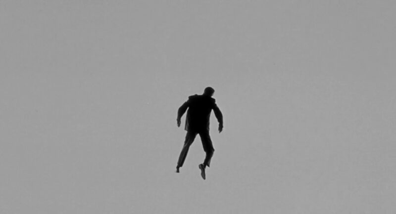 The silhouette of a man's body against a gray background