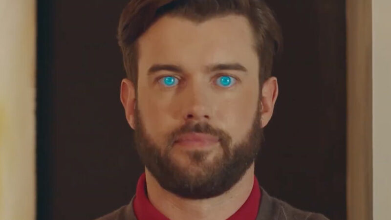 A man with glowing blue eyes