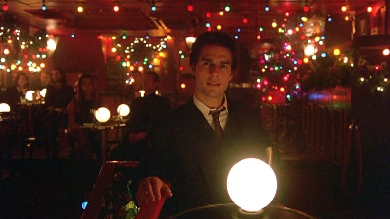 Bill Harford sits in a bar surrounded by Christmas lights