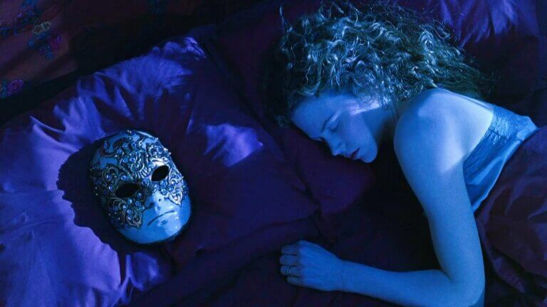 Alice Harford lies in her bed as a mask rests next to her