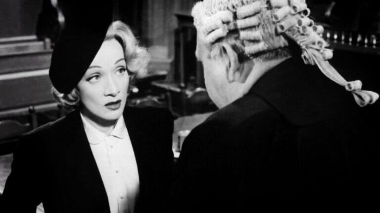 Christine Vole looks up at Sir Wilfrid Robarts in a courtroom