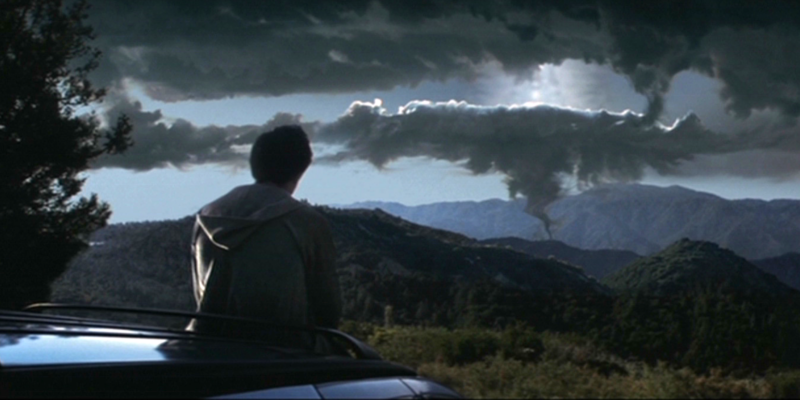 Donnie looks out onto the horizon as a cloud twists into a tornado shape