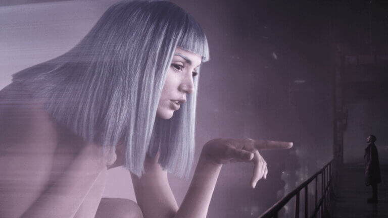 A giant hologram woman reaches out to a man on a bridge.