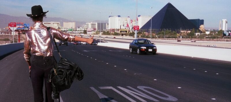 Nomi hitches a ride on a Las Vegas highway