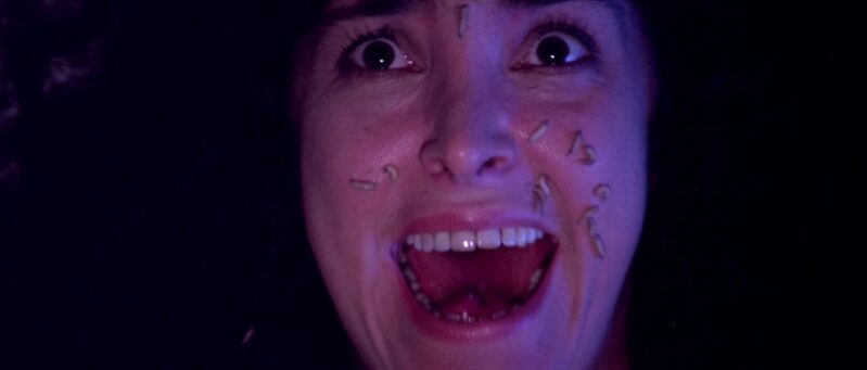 A girl screams in terror as maggots cover her face
