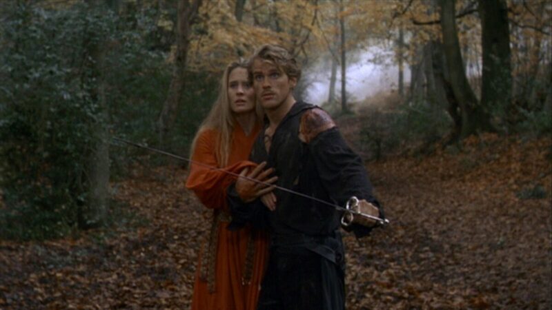 Westley protects Buttercup from Prince Humperdinck in a forest