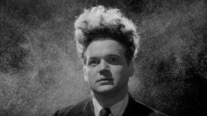 Henry Spencer looks on as particles float all around him