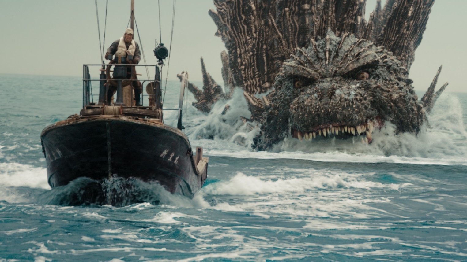 Godzilla menacingly pursues a boat