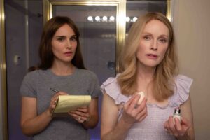 Two women look in a mirror